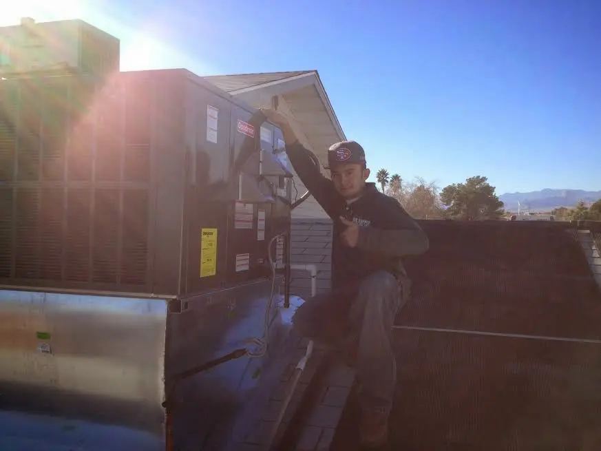 HVAC technician performing Boiler Repair on a rooftop unit in San Jose